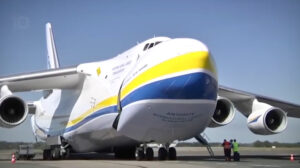 Antonov cargo plane parked on airport runway.